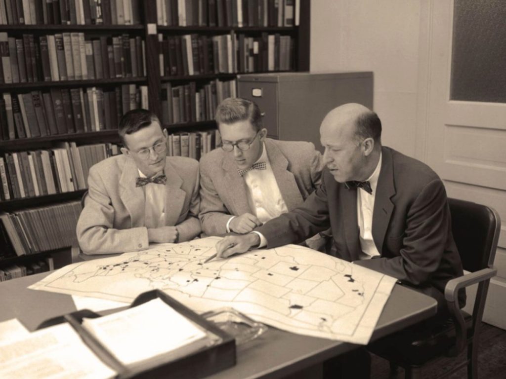 Pictured in this photograph from the Bentley Historical Library, from left to right are Philip E. Converse, Warren E. Miller, and Angus Campbell, circa 1956.